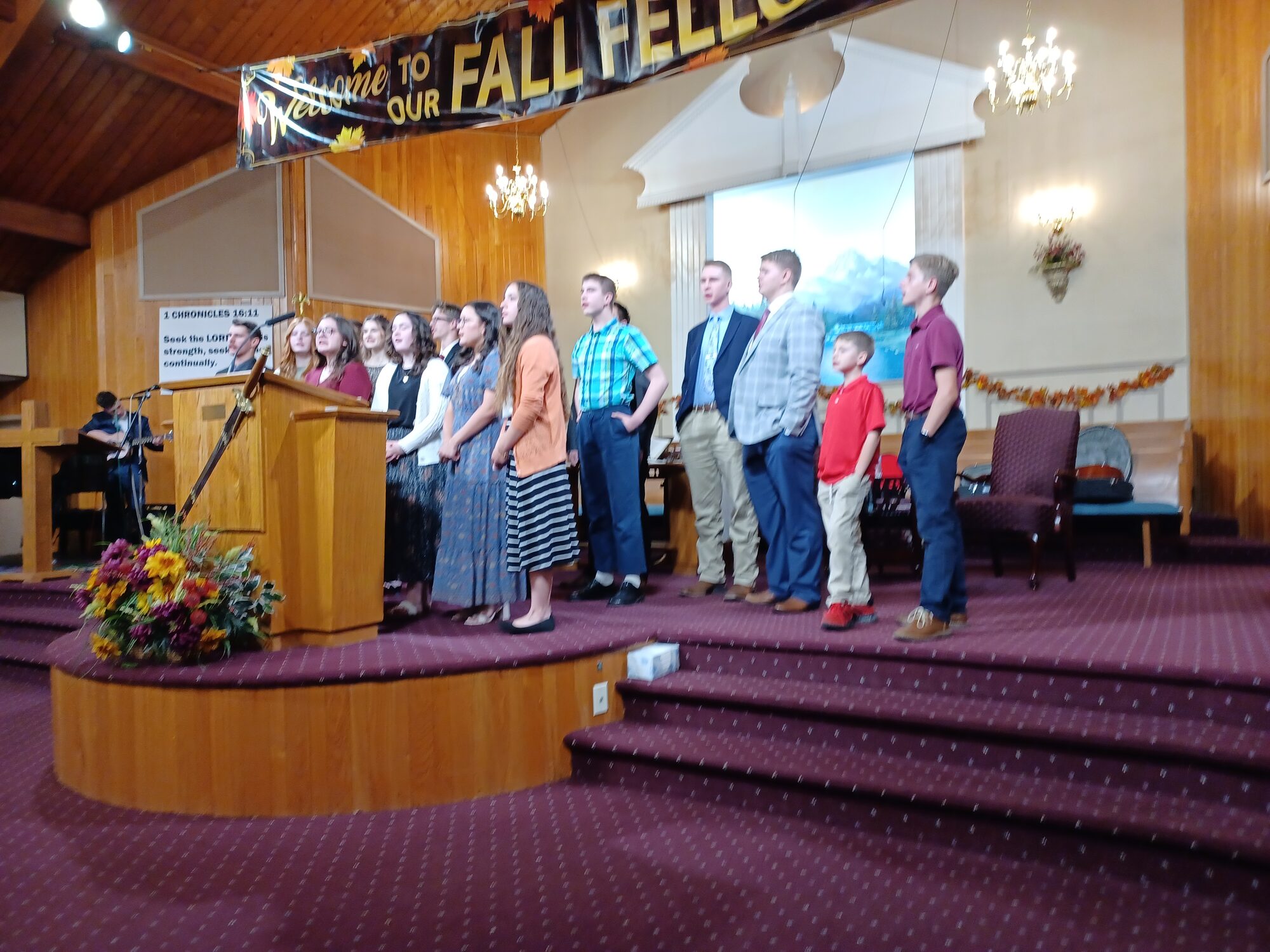 Young people singing from the platform during the Fall Fellowship at Prayer Baptist Church